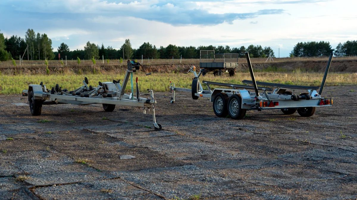 An empty military vehicle parked in a quiet field under a grey sky.